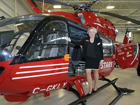 STARS president and CEO Andrea Robertson on an Airbus H145 helicopter at Edmonton International Airport on Wednesday, Feb. 5, 2020 after Capital Power announced funding of $1 million in support of the STARS air ambulance fleet renewal project.