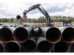 CP-Web.  Pipe for the Trans Mountain pipeline is unloaded in Edson, Alta. on Tuesday June 18, 2019. Lawyers for the Canadian government say it conducted a new round of consultations with Indigenous groups about the Trans Mountain pipeline expansion that was reasonable, adequate and fair.