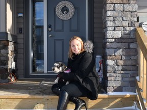 Christine Maligec and her dog Finnegan, outside her Triomphe townhome.