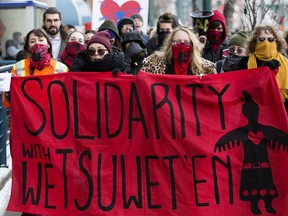 Approximately 60 protesters rally in solidarity with Wet'suwet'en Hereditary Chiefs, as they march along Jasper Avenue near 108 Street, in Edmonton Friday Feb. 14, 2020. Approximately 20 Edmonton Police Service members were on hand during the protest. Photo by David Bloom