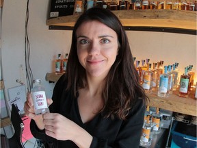 Co-founder Andrea Shubert with a bottle of Scona Community Sani, which Strathcona Spirits is offering free.