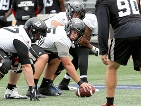 Offensive lineman Mark Korte (65) prepares to snap the ball during Ottawa Redblacks practice at TD Place Stadium on June 14, 2018.