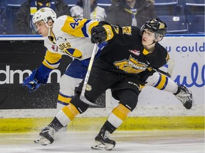 Saskatoon Blades forward Chase Wouters attempts to hit Brandon Wheat Kings forward Ridly Greig during WHL action at SaskTel Centre in Saskatoon on Wednesday, February 12, 2020.