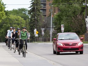 A group of cyclists heads down 83 Avenue near 106 Street on a bike ride hosted by the City of Edmonton's Bike Street Team on June 5, 2019, in Edmonton.