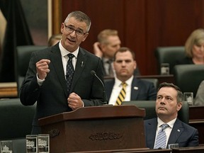 Travis Toews (Alberta Minister of Finance and President of the Treasury Board) delivers his provincial budget speech at the Alberta Legislature in Edmonton on Thursday February 27, 2020, as Alberta Premier Jason Kenney (right) looks on.