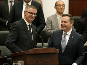 Travis Toews (left, Alberta Minister of Finance and President of the Treasury Board) and Alberta Premier Jason Kenney (right) are all smiles after Toews delivered his provincial budget speech at the Alberta Legislature in Edmonton on Thursday February 27, 2020.