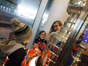 Newly minter Oilers for a Day Hunter Hudson (left) and Claira Mann check out replica Stanley Cups during a tour of the Hall of Fame room at Boston Pizza's Oiler for a Day event held at Rogers Place in Edmonton, on Sunday, March 1, 2020.