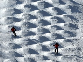 A couple of skiers try their luck on the moguls as the sunlight creates a nice visual pattern effect at Snow Valley Ski Club in Edmonton, March 2, 2020.