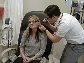 Dr. Joel Giddey examines patient Tammy Cyr at the Shale Medical Clinic in Drayton Valley, Alberta on March 3, 2020.