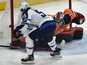 Edmonton Oilers goalie Mike Smith (41) makes the save off Winnipeg Jets Mark Scheifele (55) during NHL action at Rogers Place in Edmonton, March 11, 2020.