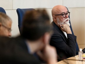 Coun. Scott McKeen, right, listens to an answer from administration during an emergency city council meeting on COVID-19 held at city hall in Edmonton on Friday, March 13, 2020.