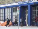 The Boyle Street Community Services building on 105 Avenue draws a crowd on a cold afternoon  on March 14, 2020. 
