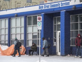 The Boyle Street Community Services building on 105 Ave. draws a crowd on a cold afternoon  on March 14, 2020.