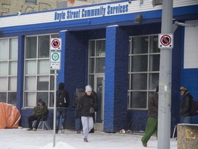 The Boyle Street Community Services building on 105 Ave. draws a crowd on a cold afternoon, March 14, 2020.