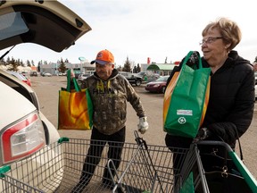 John and Morna Wowk load groceries into their SUV at Sobey's Belmont location at 13504 Victoria Trail in Edmonton, on Tuesday, March 17, 2020. The store has instituted an early morning opening to let seniors and vulnerable people shop for essentials during the ongoing COVID-19 pandemic. Photo by Ian Kucerak/Postmedia