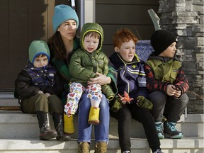 Sonja McGee and her children Patrick, left, Nicholas, Gibson and Joseph get some fresh air outside their home in Edmonton on Wednesday, March 18, 2020. All schools in the province of Alberta have been cancelled until further notice due to the global COVID-19 pandemic.