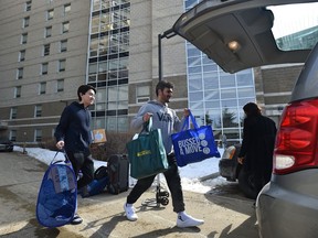 First year Calgary students Abdallah Alwan and Jeremy Fung are moving out of residents at Schaffer Hall University of Alberta due to the school closing from the COIVD pandemic in Edmonton, March 18, 2020.