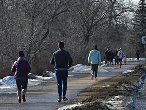 Along River Valley Rd. people hit the trails and also the parks Saturday with temperatures rising above zero in Edmonton, March 21, 2020.