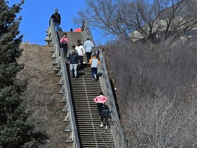 Along River Valley Rd. people hit the stairs, trails and also the parks Saturday with temperatures rising above zero in Edmonton, March 21, 2020.