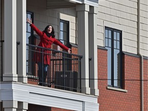 Opera singer Cara Lianne McLeod singing from her fourth-floor balcony along 98 Avenue in Edmonton on March 22, 2020.