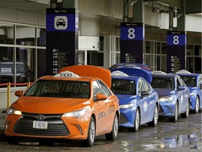 Taxis wait for passengers at the Edmonton International Airport on March 23, 2020.