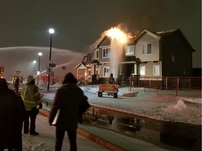 Edmonton firefighters tackle a late night  blaze at a house in the Griesbach neighbourhood on Monday, March 23, 2020. Supplied photo/Jesse Allen Whitnack)