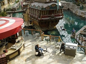 A man drinks a coffee at West Edmonton Mall on Tuesday March 24, 2020. Many businesses at the largest shopping mall in Canada have closed.