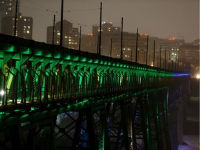 The High Level Bridge is seen lit green and blue in honour of healthcare workers everywhere in Edmonton on Tuesday, March 24, 2020.