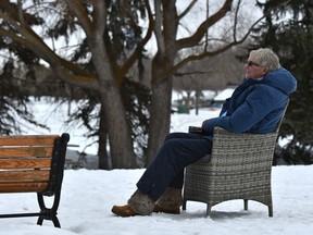 Elaine Miklos relaxing, chose to bring her own chair instead of using the bench at Hawrelak Park in Edmonton, March 26, 2020. Ed Kaiser/Postmedia