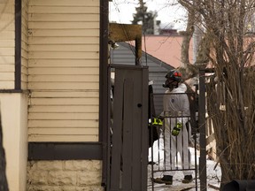Fire investigators inspect the fire aftermath at a house that is set for demolition at 10023 83 Avenue on Friday, March 27, 2020, in Edmonton.