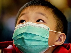 A young boy wears a face mask in public for protection against novel coronavirus. An Edmonton businessman who travelled to the United States is the second presumptive case of COVID-19 in Alberta. The chief medical officer of Alberta confirmed this case on March 6, 2020 after announcing the province's first reported presumptive case of novel coronavirus in Calgary  yesterday.