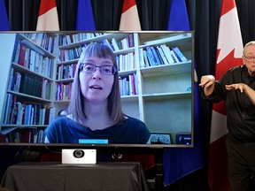 Sign language interpreter Randy Dziwenka (right) translates comments from Dr. Deena Hinshaw (Alberta Chief Medical Officer of Health) at the Alberta Legislature in Edmonton on March 16, 2020. Dr. Hinshaw provided the update March 16, 2020 by video conference, after self-isolating herself at home due to symptoms of a cold. She has been tested for COVID-19 and is waiting for the result. (PHOTO BY LARRY WONG/POSTMEDIA)