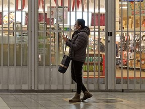 A shopper at West Edmonton Mall on Tuesday March 24, 2020. Many businesses at the largest shopping mall in Canada are closed due to the global COVID-19 pandemic. (PHOTO BY LARRY WONG/POSTMEDIA)