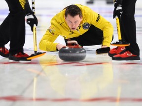 Team Manitoba skip Jason Gunnlaugson delivers while taking on Quebec at the Brier in Kingston, Ont., on March 1, 2020.