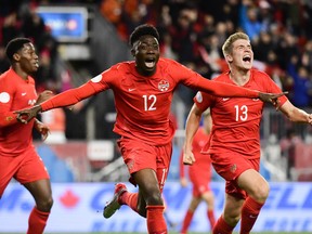 Team Canada’s Alphonso Davies, left, and Liam Fraser celebrate Davies’ goal against the United States in a CONCACAF Nations League match at BMO Field on Oct. 15, 2019.