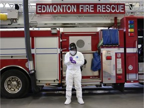 An Edmonton firefighter demonstrates what members will be wearing when responding to COVID-19 calls in the city. Firefighters have also stepped up other preventive measures including social distancing unless helping someone and stepping up hand washing and sanitization. Recieved in Edmonton Monday March 23, 2020. Supplied Photo by Edmonton Fire Rescue Services