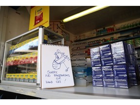 A stall displays a sign after running out of facemasks and antibacterial hand sanitizer due to the coronavirus outbreak.