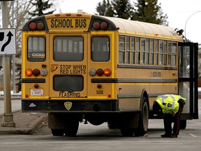 Police are investigating an accident scene at Castle Downs Road and 162 Avenue on Wednesday morning. A 12-year-old boy was struck by a school bus and taken to hospital by ambulance with serious injuries. (PHOTO BY LARRY WONG/POSTMEDIA)