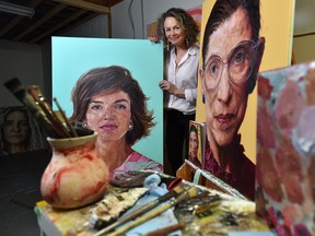 Shana Wilson in her studio next to two portraits that she has painted and will appear in Time magazine, one on the cover and the other inside, in Edmonton, March 6, 2020.