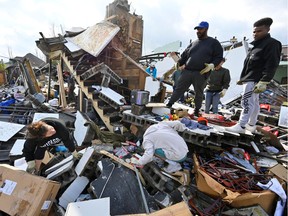 People try to salvage merchandise at Music City Vintage after a tornado hit eastern Nashville, Tennessee, U.S., March 3, 2020.
