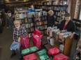 Audreys Books co-owner Steve Budnarchuk and store manager Kelly Dyer (front) are offering delivery service to help keep the bookstore afloat during the COVID-19 crisis.