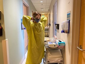 A health-care worker prepares to see patients at the new COVID-19 clinic at the Lois Hole Hospital for Women.