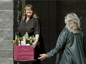 Bonnie Grimmon, owner of The Gilded Pear, offers curb side service outside her west end salon.