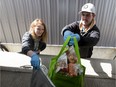 Courtney Konschuh of Grace's Traditional Foods packs groceries with Steven Souto of Steve and Dan's Fresh B.C. Fruit in a warehouse near Devon on Wednesday, April 22, 2020. The two are part of a new, online business delivering farmers market foods to homes in Edmonton and the surrounding area.