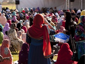 People take part in the Eid ul Fitr Prayers put on by the Marakz ul Islam Society of Edmonton at Millwoods Park in Edmonton. Eid ul Fitr commemorates the end of the Holy month of Ramadan. File photo.