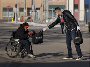 Dan Johnstone, also know as  Can Man Dan, hands out nearly 200 emergency packages with much-needed supplies to Edmonton's inner-city homeless population on Friday, March 20, 2020, in Edmonton. The bag includes $30 worth of items like peanut butter, hand sanitizing wipes and granola bars.