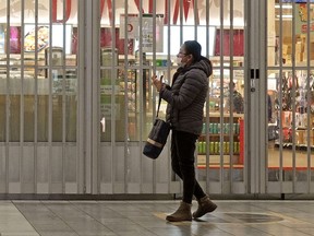 A shopper at West Edmonton Mall on Tuesday March 24, 2020. Many businesses at the largest shopping mall in Canada have closed.