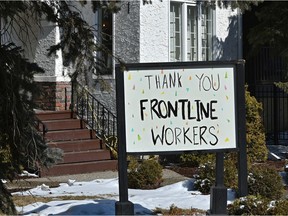 Homeowners thanking frontline workers on their front lawn along 102 Ave. and 131 St. in Edmonton, March 25, 2020.