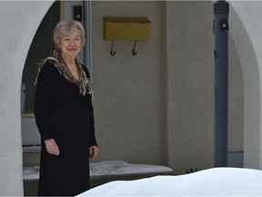 Barbara "Bonnie" Phillips, 84, stands outside the Edmonton bed and breakfast she has owned for five years on Friday, April 3, 2020. She had to close in March because of the pandemic.