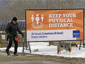 Vicki Harber and her dog "Dixie" take a walk at Terwillegar dog park in Edmonton on Friday April 3, 2020. Beginning Saturday April 4, 2020, all dogs must now be leashed at off-leash dog parks in the city and all fenced-in dog parks owned by the City of Edmonton are closed until further notice due to the coronavirus pandemic.